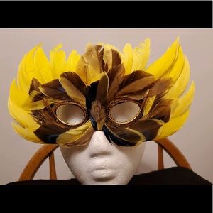 Yellow feather Mardi Gras or masquerade mask.